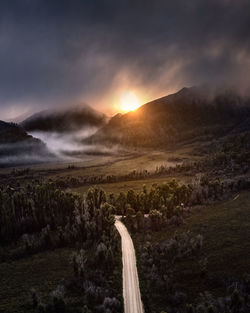 Scenic view of land against sky during sunset