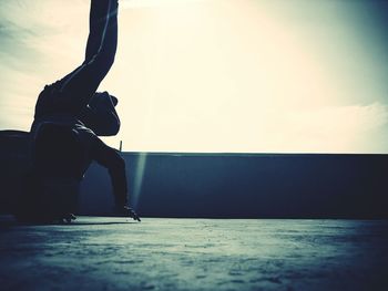 Silhouette man in sea against clear sky
