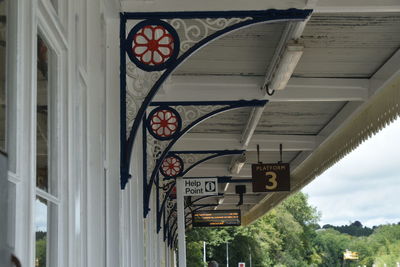 Low angle view of information sign against building