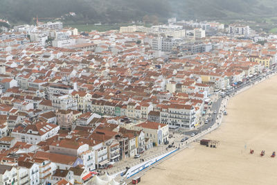 Top view of the streets with white houses and orange tiled roofs, an ancient portuguese city