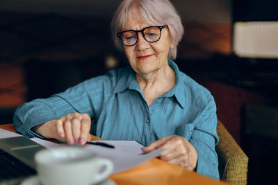 Senior woman working at cafe