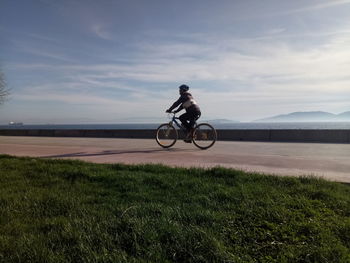 Man riding bicycle on field