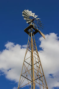 Low angle view of traditional windmill against blue sky