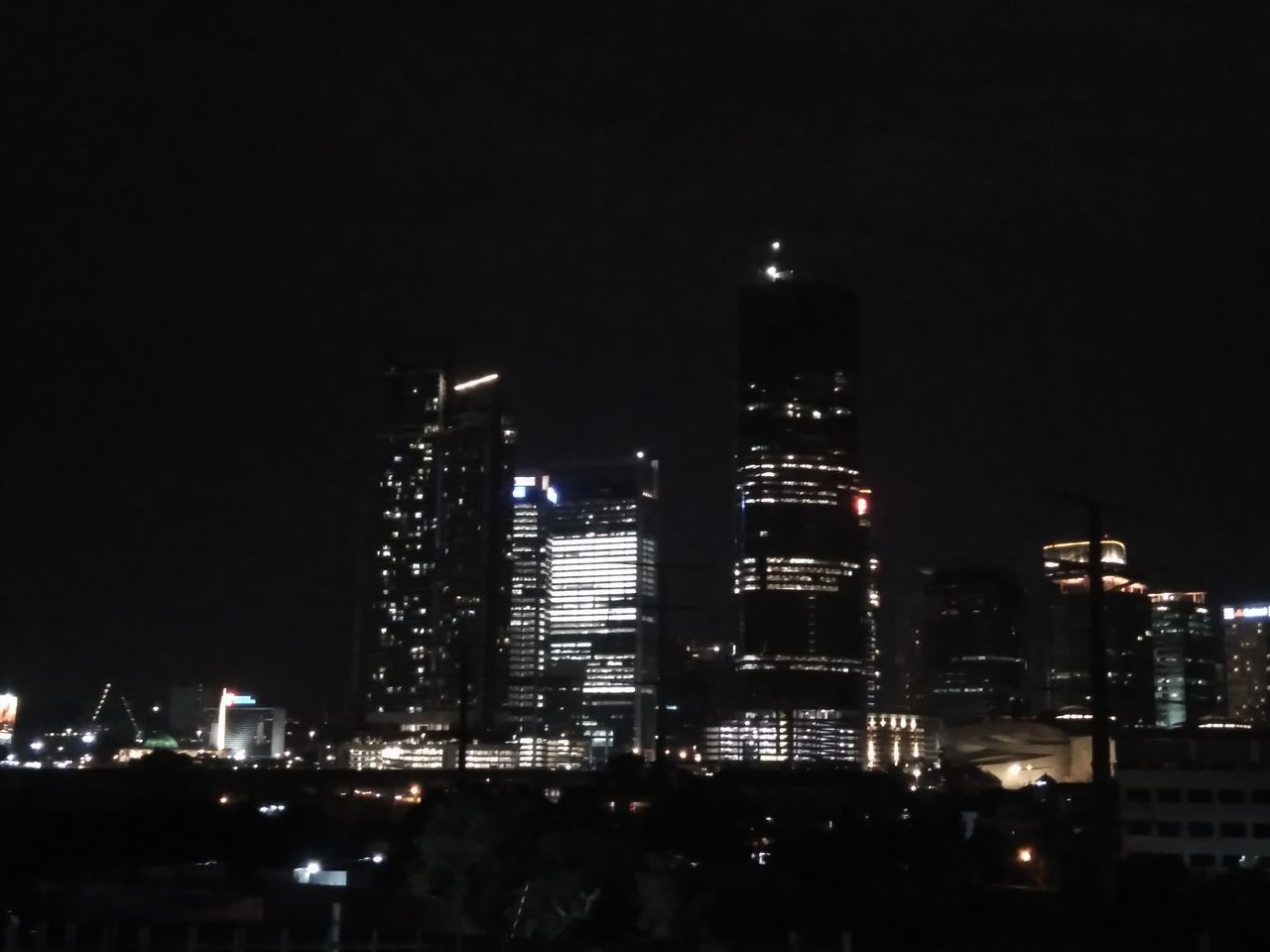 ILLUMINATED MODERN BUILDINGS IN CITY AT NIGHT