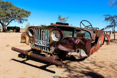 Abandoned truck on road against sky