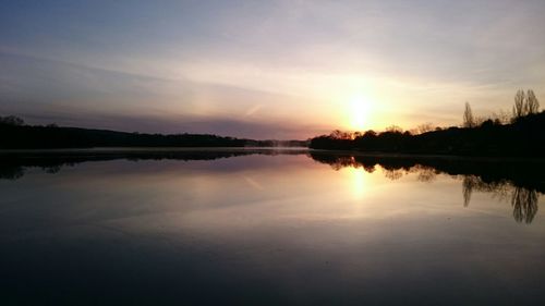 Scenic view of lake at sunset