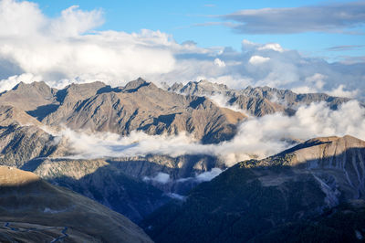 Scenic view of mountains against cloudy sky