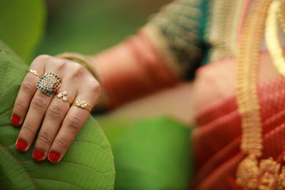 Cropped hand of woman with henna tattoo