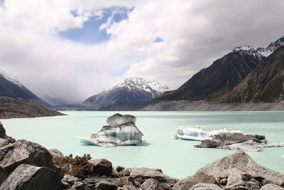 Scenic view of sea and mountains against sky