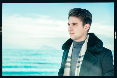 Portrait of man looking at sea against sky