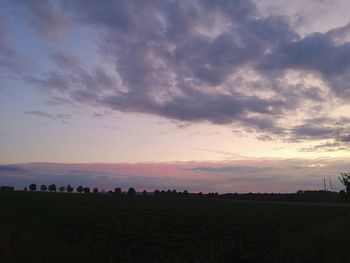 Scenic view of field against sky during sunset