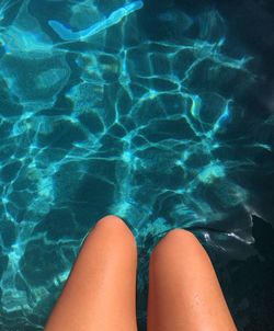 Midsection of woman in swimming pool