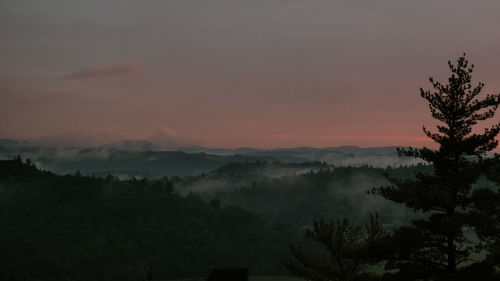 Scenic view of silhouette mountains against sky during sunset