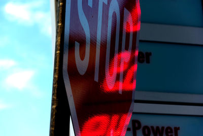 Low angle view of text on building against sky