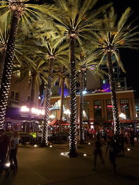 People in illuminated city at night