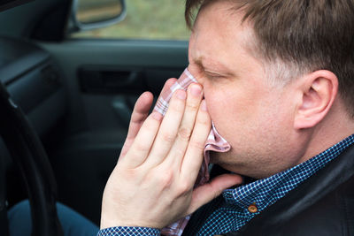 Portrait of man with hand in car