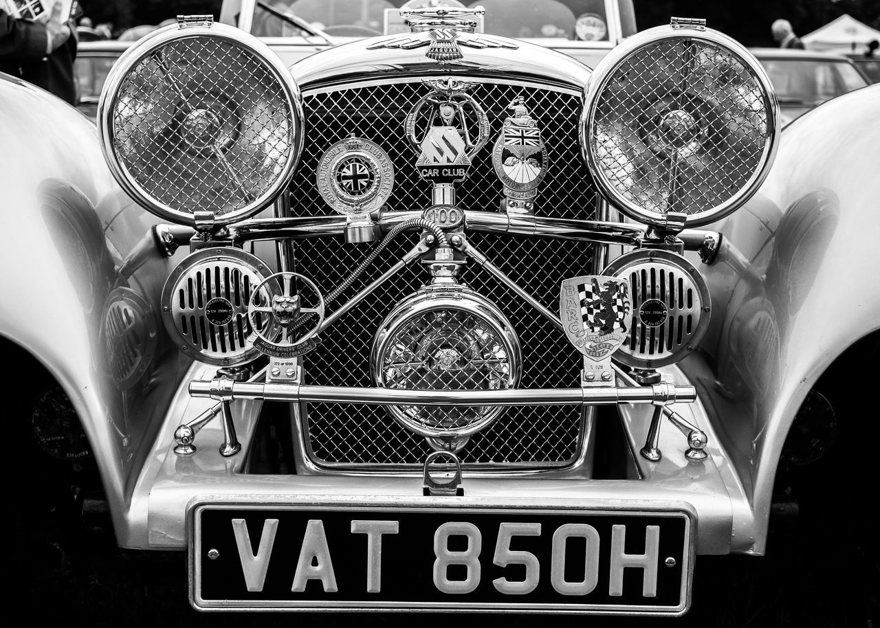 CLOSE-UP OF VINTAGE CAR ON BUS