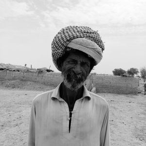 Portrait of man wearing turban against sky