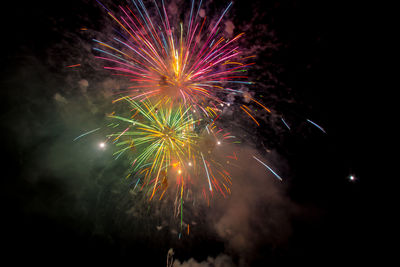 Low angle view of firework display at night