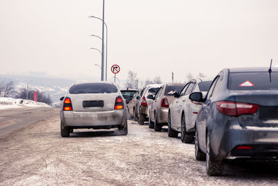 View of cars on road against clear sky