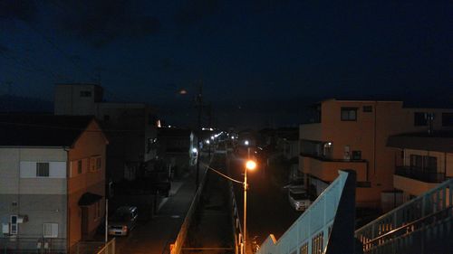 Illuminated city against sky at night