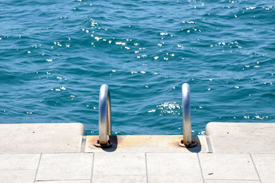 High angle view of pier over sea on sunny day