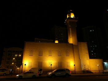 Illuminated street light in city at night