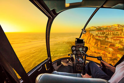 Man sitting at sea seen through airplane