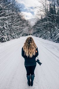 Woman on snow covered landscape