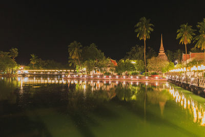 Scenic view of lake against sky at night