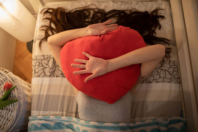 Midsection of woman holding heart shape