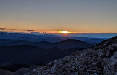 Scenic view of mountains against sky during sunset