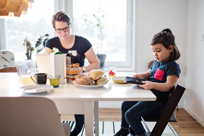 Woman sitting on table at home