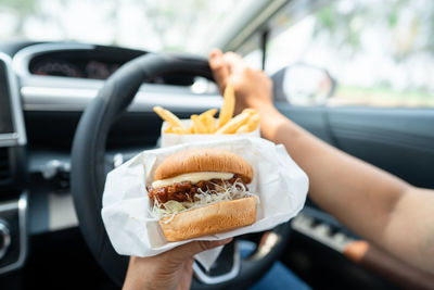 Cropped hand of woman holding food