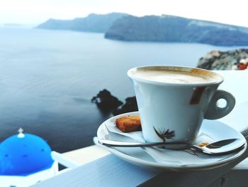 Close-up of coffee on table by the sea