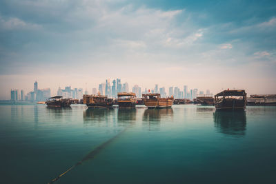 Scenic view of sea by buildings against sky