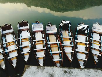 Stack of fishing boats moored in lake