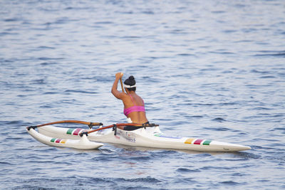 Woman in boat on sea