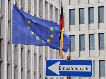 Information sign on pole against building