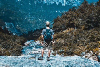 Full length rear view of man walking on mountain