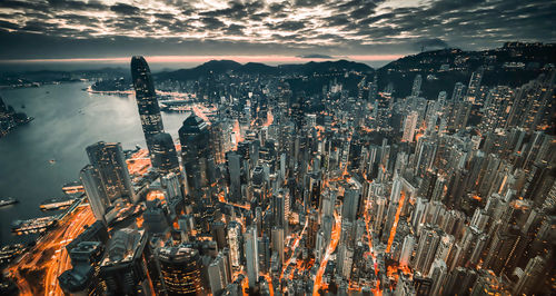 High angle view of illuminated buildings against sky during sunset