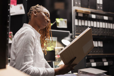 Side view of woman using digital tablet