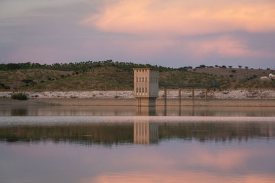 Lucefecit dam in terena with reflection on the lake reservoir at sunset, in portugal