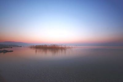 Scenic view of sea against clear sky during sunset