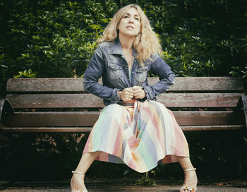 Portrait of smiling woman sitting on bench