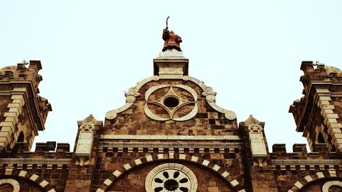 Low angle view of clock tower against clear sky