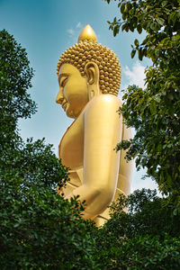 Low angle view of statue against trees