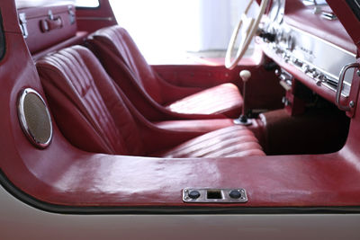 Detail of a classic car with wing doors with borders disappearing into the bright light