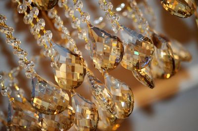 Close-up of chandelier hanging on glass