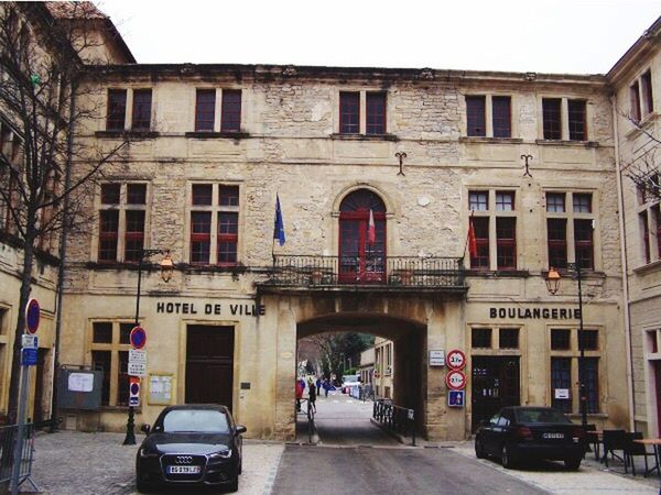 CARS ON ROAD ALONG BUILDINGS